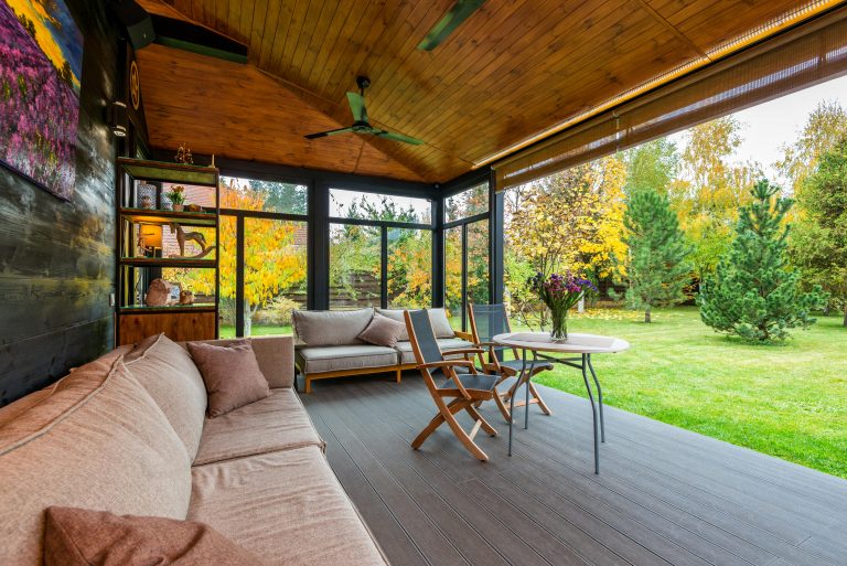 a patio with a couch and chairs