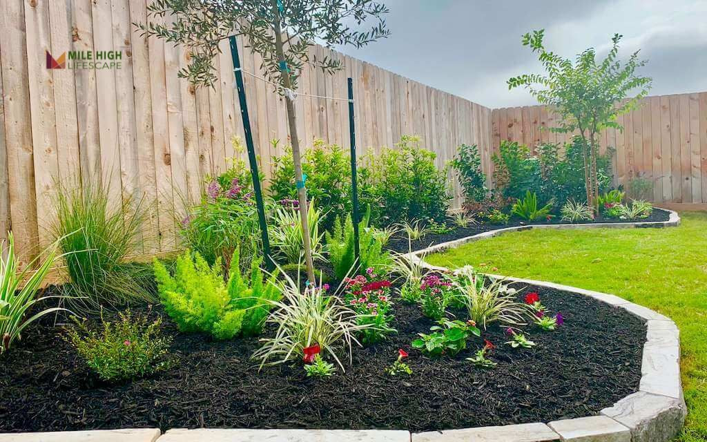 Flagstone-Rimmed Flower Bed with Mulch Interior