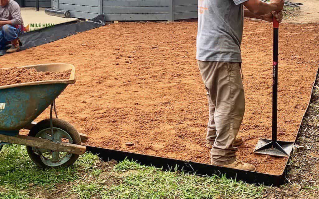 Add a crushed gravel or decomposed granite base layer