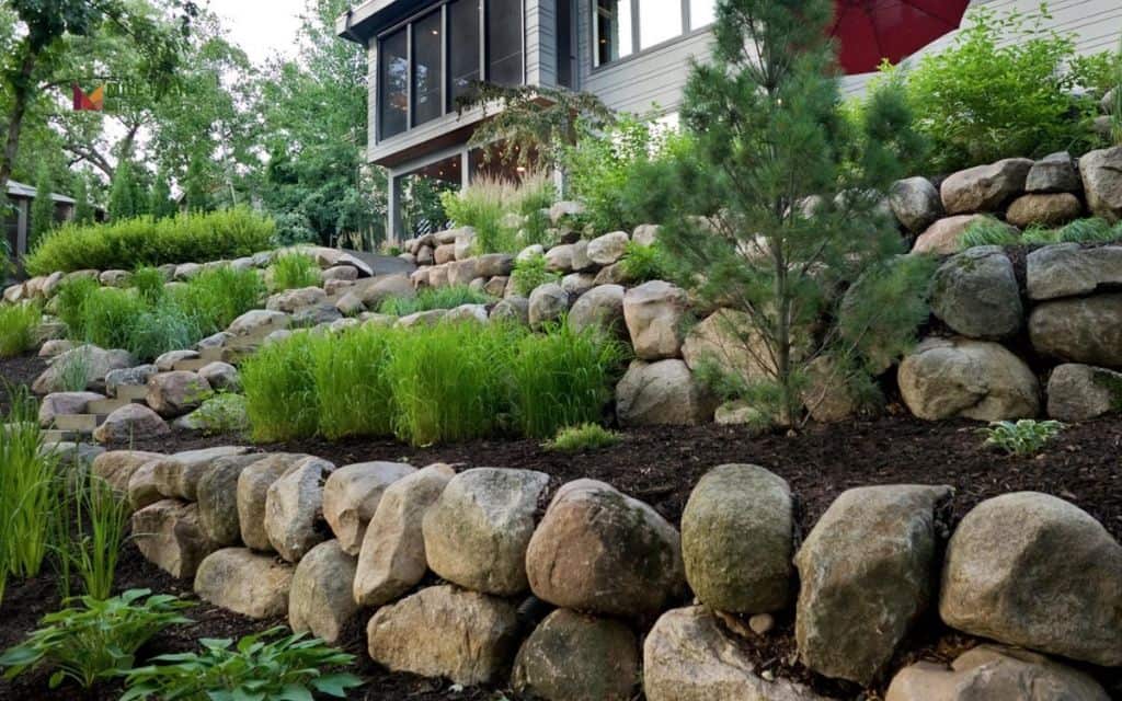 Tiered boulder and mulch slopes