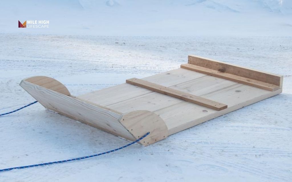 Slide on a sled, tarp, or stone boat