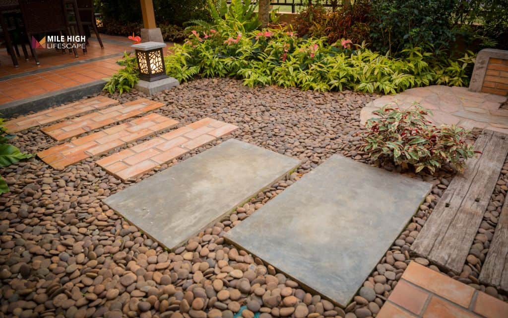 Front yard river rock landscaping along walkways