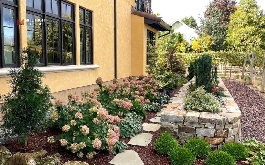 Rock flower bed in front of house
