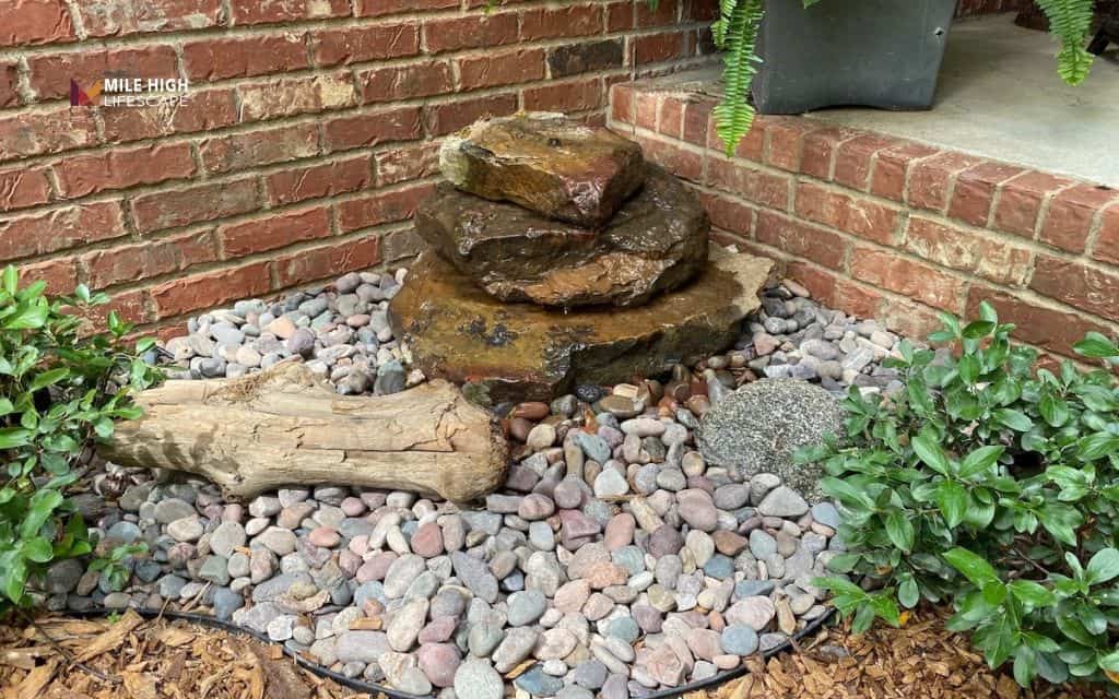 Small rock water feature in a gravel bed