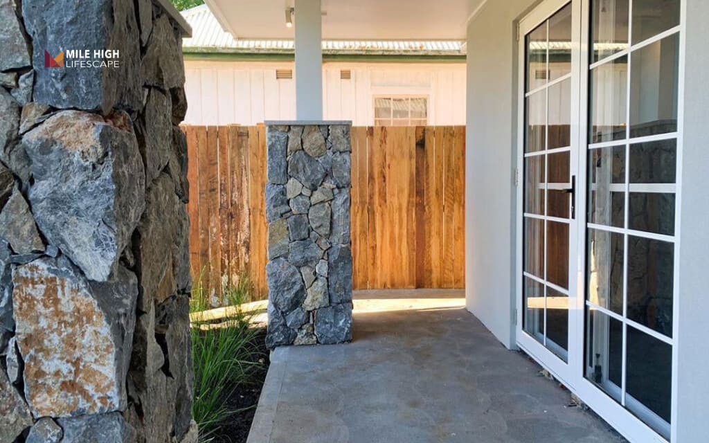 Front house fence ideas: Combine stone pillars with wood panels